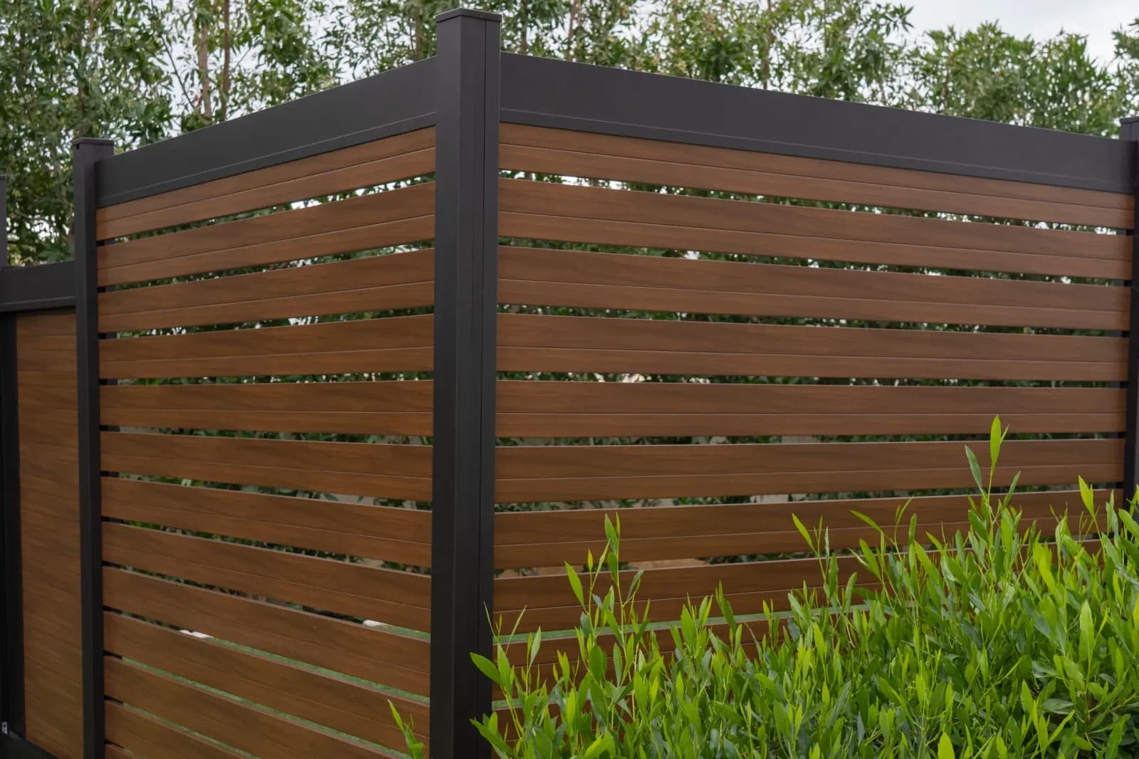 Aluminum semi-privacy fence installed in a residential backyard