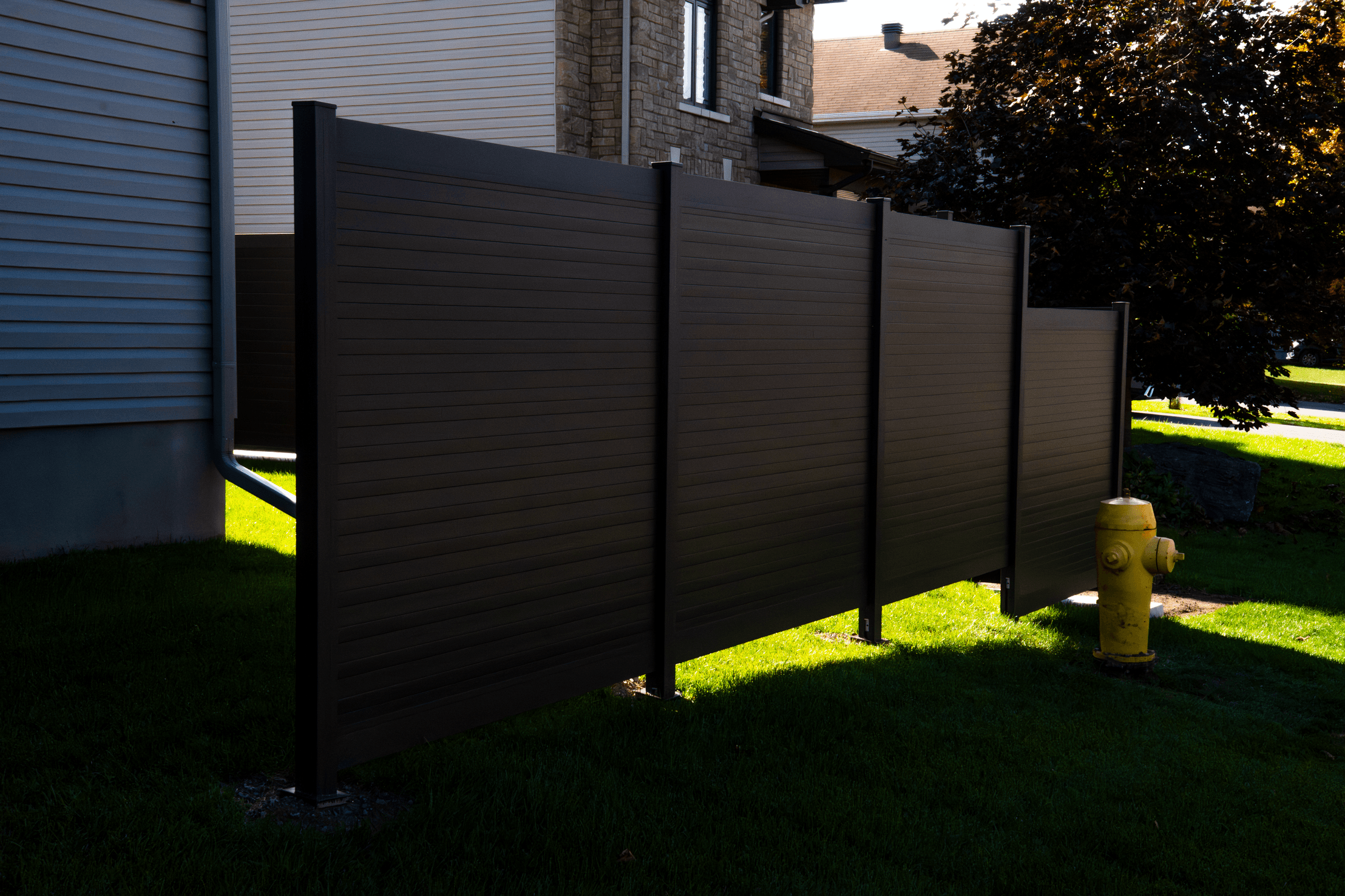 Installed PrimeAlux aluminum privacy fence panels in a Canadian residential setting