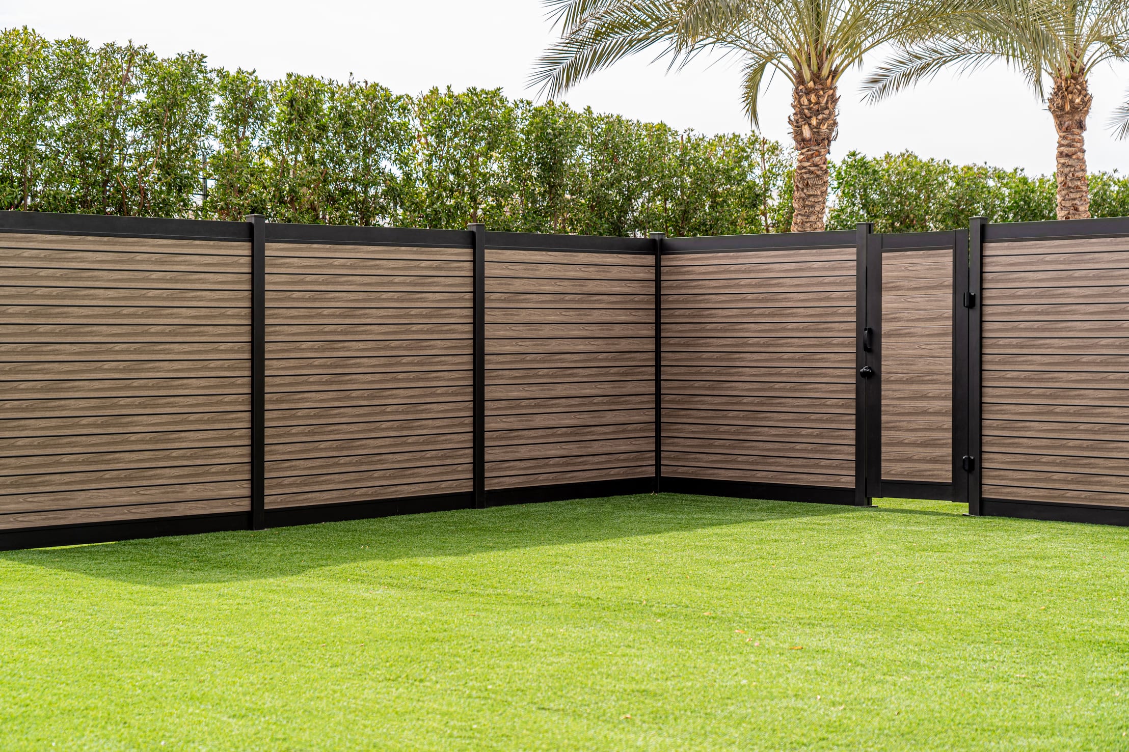 Aluminum pool fence with self-closing gate installed in a Canadian backyard
